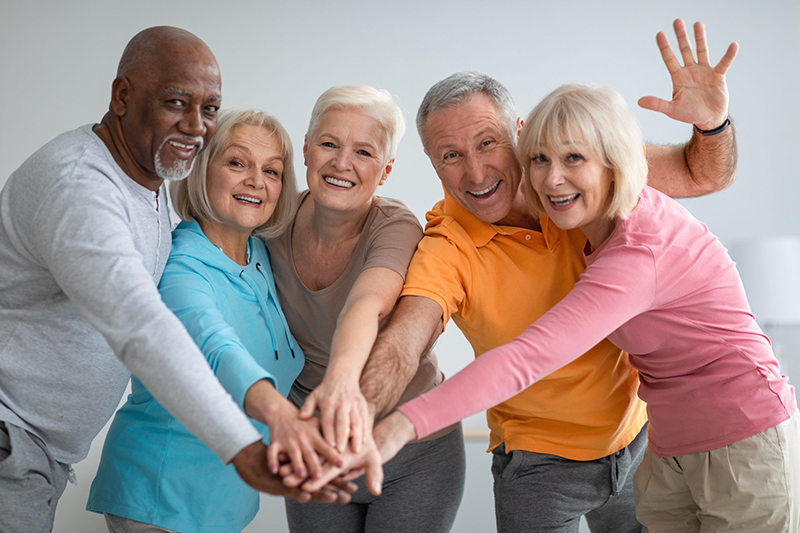 Group of seniors with hands in